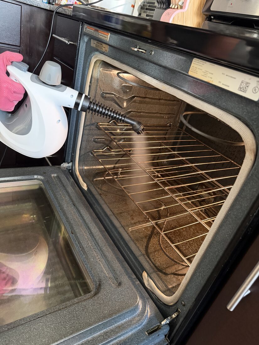 Customer steam cleaning the inside of an oven with the Velmora